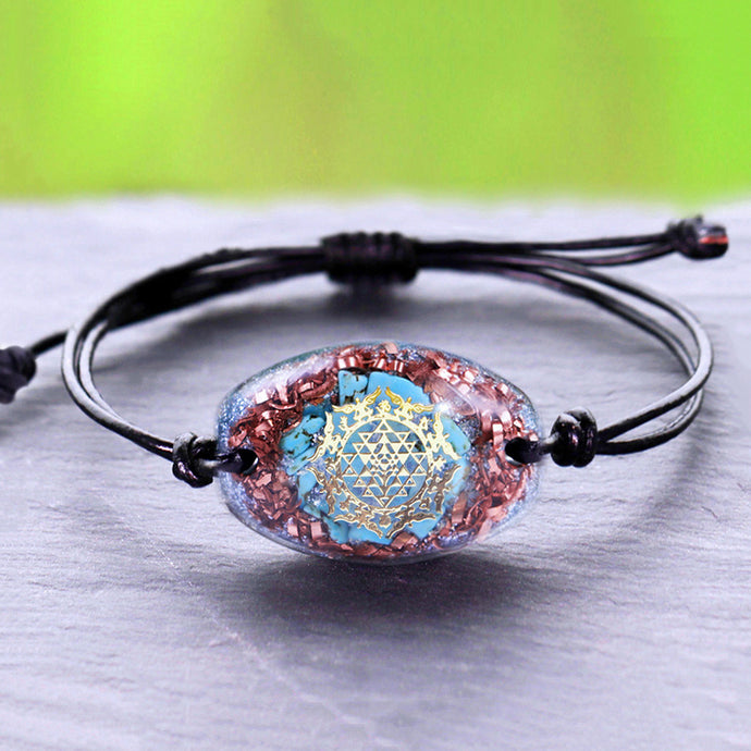 Orgonite bracelet with Turquoise stones surrounded by copper shavings. Features a central Sri Yantra energy patch.
