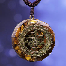 Load image into Gallery viewer, Orgonite necklace with Tiger's Eye and gold Sri Yantra emblem.