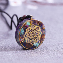Load image into Gallery viewer, Orgonite necklace with Turquoise and Tigers Eye crystals. The orgonite pendant has a copper foil energy patch with the Sri Yantra emblem.