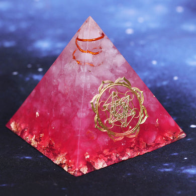 A vibrant pink orgonite pyramid with quartz crystals and a quartz-copper energy coil. Features a copper Metatron's Cube energy patch and gold foil shavings.