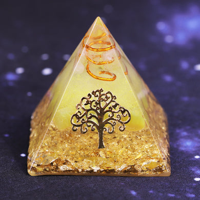 An orgonite pyramid with Quartz and Yellow Agate crystals. Features quartz in a copper energy coil, a Tree of Life energy patch and gold foil shavings.