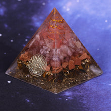 Load image into Gallery viewer, An orgonite pyramid with Strawberry Quartz, Tiger's Eye and Goldstone crystals. Features a Quartz crystal set in a Copper Energy Coil and Flower of Life copper energy patch.