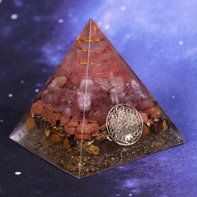 An orgonite pyramid with Strawberry Quartz, Tiger's Eye and Goldstone crystals. Features a Quartz crystal set in a Copper Energy Coil and Flower of Life copper energy patch.