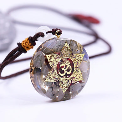 Orgonite pendant necklace with Garnet and Labradorite stones. Features a Lotus Flower and Aum copper energy patch in the center.