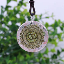Load image into Gallery viewer, A soft pink orgonite necklace featuring an Olivine crystal center surrounded by warm Rose Quartz. crystals. Features a front-facing 'AUM' copper energy patch.