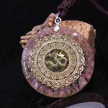 Load image into Gallery viewer, A soft pink orgonite necklace featuring an Olivine crystal center surrounded by warm Rose Quartz. crystals. Features a front-facing 'AUM' copper energy patch.