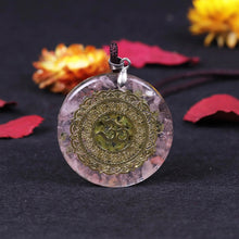 Load image into Gallery viewer, A soft pink orgonite necklace featuring an Olivine crystal center surrounded by warm Rose Quartz. crystals. Features a front-facing 'AUM' copper energy patch.