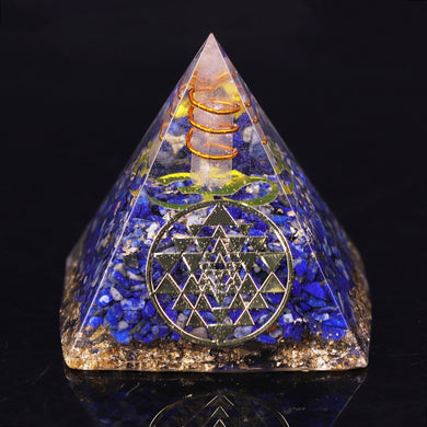 An orgonite pyramid with Lapis Lazuli & Quartz crystals. Includes a Sri Yantra and Aum copper energy patch.