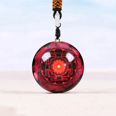 A red orgonite necklace with a Lotus flower design. Orgonite pendant contains Red coral, Red Sea Glass, Resin, Gold Foil