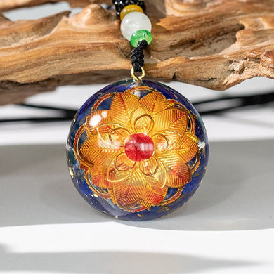Golden lotus flower and lapis lazuli orgonite necklace from The Orgone Shop. 