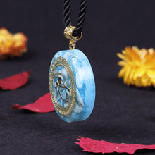 Load image into Gallery viewer, An orgonite pendant necklace with Amazonite stones and a copper &quot;Eye of Horus&quot; energy patch.