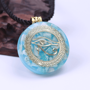 An orgonite pendant necklace with Amazonite stones and a copper "Eye of Horus" energy patch.