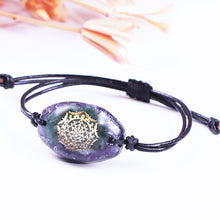 Load image into Gallery viewer, Orgonite bracelet with Amethyst stones surrounding a central cluster of Green Aventurine stones. Features silver foil shavings and a Sri Yantra energy patch.