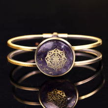 Load image into Gallery viewer, An orgonite bracelet with a brushed copper bangle. Amethyst stones and gold foil shavings surround a sacred Sri Yantra energy patch.