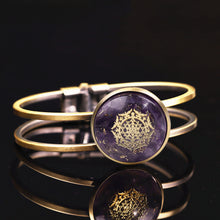 Load image into Gallery viewer, An orgonite bracelet with a brushed copper bangle. Amethyst stones and gold foil shavings surround a sacred Sri Yantra energy patch.