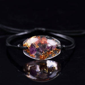 An orgonite bracelet with Amethyst crystals and Gold Foil shavings sold at The Orgone Shop.