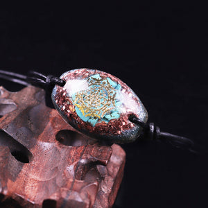 Orgonite bracelet with Turquoise stones surrounded by copper shavings. Features a central Sri Yantra energy patch.