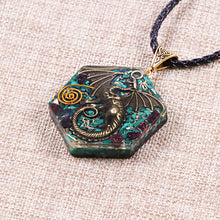 Load image into Gallery viewer, Orgonite necklace with Malachite and Garnet crystals. Features a metal dragon and copper energy coil.