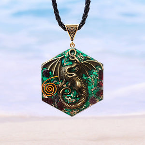 Orgonite pendant necklace with malachite and garnet stones. Features a metal dragon and copper energy spire on the front.