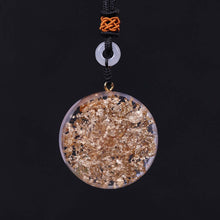 Load image into Gallery viewer, Rear view of an orgonite pendant necklace with seven stones, displaying the gold foil shavings.