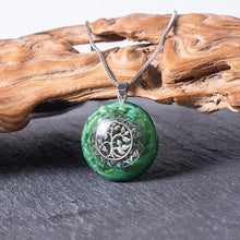 Load image into Gallery viewer, Orgonite pendant necklace made with green peridot crystals and a silver chain.