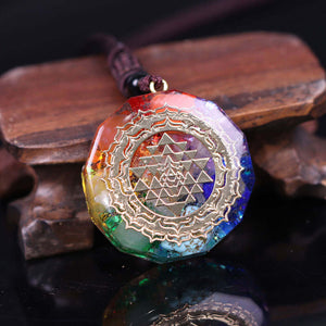 An orgonite necklace with seven stones and a copper Sri Yantra energy patch.