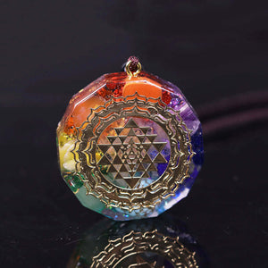 An orgonite necklace with seven stones and a copper Sri Yantra energy patch.