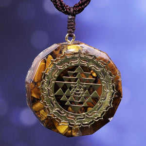 Orgonite necklace with Tiger's Eye and gold Sri Yantra emblem.