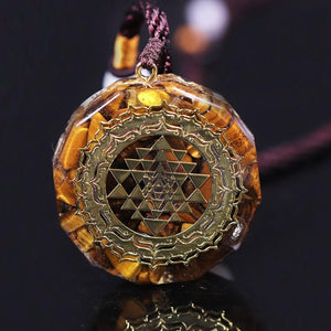 Orgonite necklace with Tiger's Eye and gold Sri Yantra emblem.