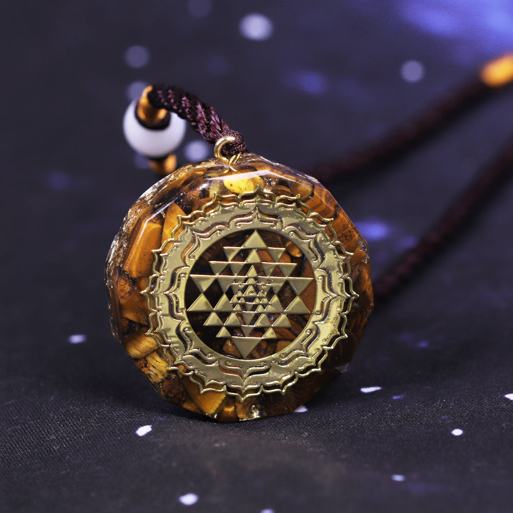 Orgonite necklace with Tiger's Eye and gold Sri Yantra emblem.