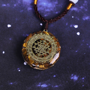 Orgonite necklace with Tiger's Eye and gold Sri Yantra emblem.