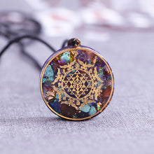 Load image into Gallery viewer, Orgonite necklace with Turquoise and Tigers Eye crystals. The orgonite pendant has a copper foil energy patch with the Sri Yantra emblem.