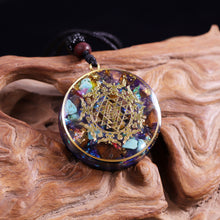 Load image into Gallery viewer, Orgonite necklace with Turquoise and Tigers Eye crystals. The orgonite pendant has a copper foil energy patch with the Sri Yantra emblem.