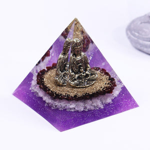 Orgonite pyramid with Rose Quartz crystals, gold foil shavings and a Buddha statue. 