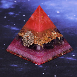 Orgonite pyramid with Amethyst and Quartz crystals. Features a Lotus Flower and Aum copper energy patch.