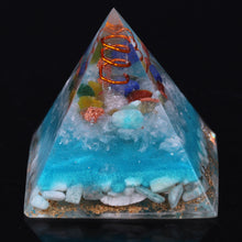 Load image into Gallery viewer, Sky blue orgonite pyramid with seven crystal stones. Features a quartz and copper energy coil, with a copper Tree of Life energy patch.