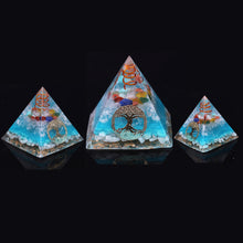 Load image into Gallery viewer, Sky blue orgonite pyramid with seven crystal stones. Features a quartz and copper energy coil, with a copper Tree of Life energy patch.