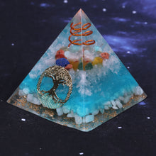 Load image into Gallery viewer, Sky blue orgonite pyramid with seven crystal stones. Features a quartz and copper energy coil, with a copper Tree of Life energy patch.