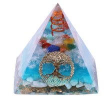 Load image into Gallery viewer, Sky blue orgonite pyramid with seven crystal stones. Features a quartz and copper energy coil, with a copper Tree of Life energy patch.