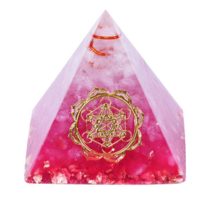 A vibrant pink orgonite pyramid with quartz crystals and a quartz-copper energy coil. Features a copper Metatron's Cube energy patch and gold foil shavings.