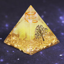 Load image into Gallery viewer, An orgonite pyramid with Quartz and Yellow Agate crystals. Features quartz in a copper energy coil, a Tree of Life energy patch and gold foil shavings.