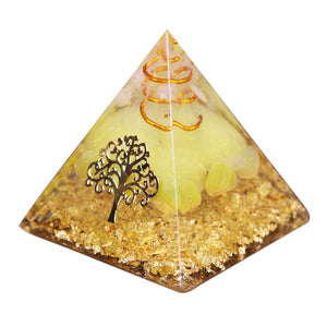 An orgonite pyramid with Quartz and Yellow Agate crystals. Features quartz in a copper energy coil, a Tree of Life energy patch and gold foil shavings.