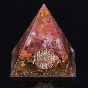 An orgonite pyramid with Strawberry Quartz, Tiger's Eye and Goldstone crystals. Features a Quartz crystal set in a Copper Energy Coil and Flower of Life copper energy patch.