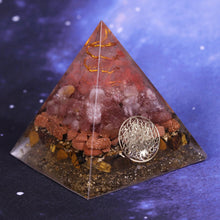 Load image into Gallery viewer, An orgonite pyramid with Strawberry Quartz, Tiger&#39;s Eye and Goldstone crystals. Features a Quartz crystal set in a Copper Energy Coil and Flower of Life copper energy patch.