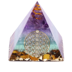 Orgonite pyramid with Tiger's Eye, Amethyst and Fluorite crystals. Includes a quartz crystal in a copper energy coil, gold foil shavings and a sacred Flower of Life energy patch.