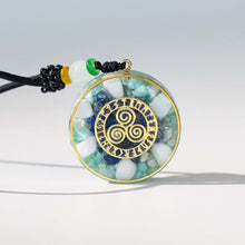 Load image into Gallery viewer, Orgonite pendant necklace with Amazonite and Lapis Lazuli stones and a Triskelion energy patch.