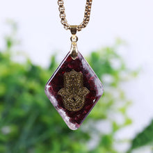 Load image into Gallery viewer, Orgonite pendant necklace with garden stones and a copper Hamsa energy patch.