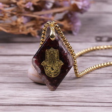 Load image into Gallery viewer, Orgonite pendant necklace with garden stones and a copper Hamsa energy patch.