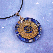 Load image into Gallery viewer, An orgonite pendant necklace with Lapis Lazuli stones and a copper Aum energy patch.