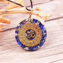 Load image into Gallery viewer, An orgonite pendant necklace with Lapis Lazuli stones and a copper Aum energy patch.